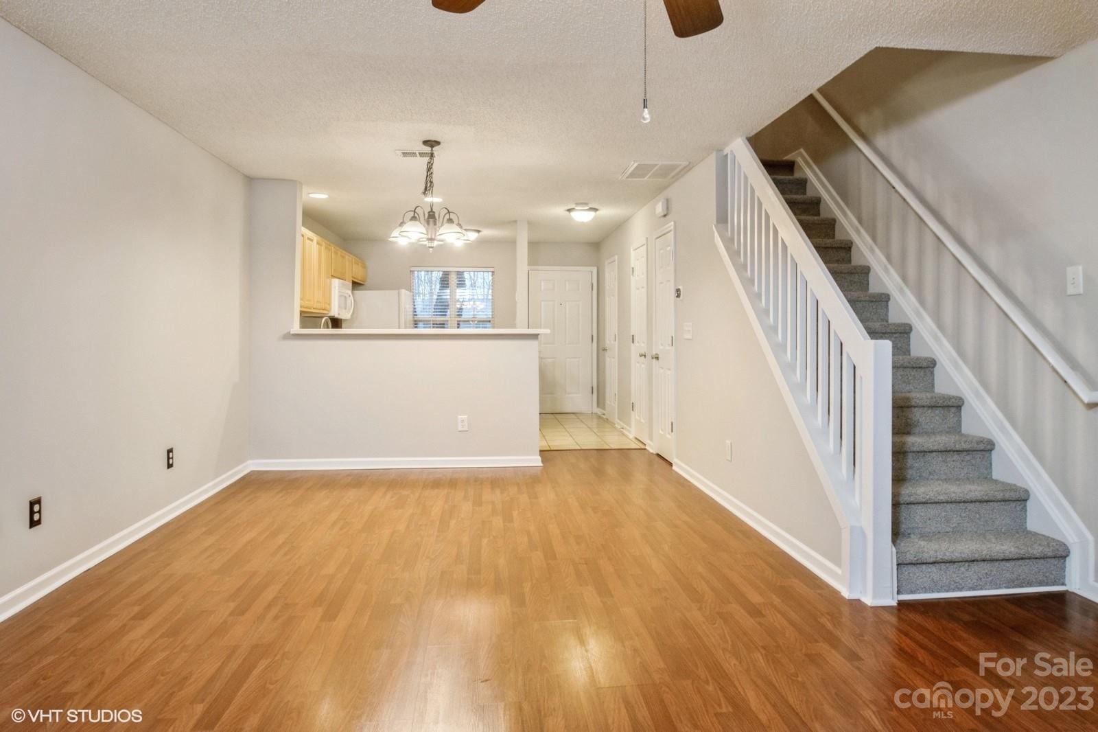 8334 Rudolph Road Charlotte, NC 28216 - Photo 6 of 31 a view of a room with wooden floor and staircase