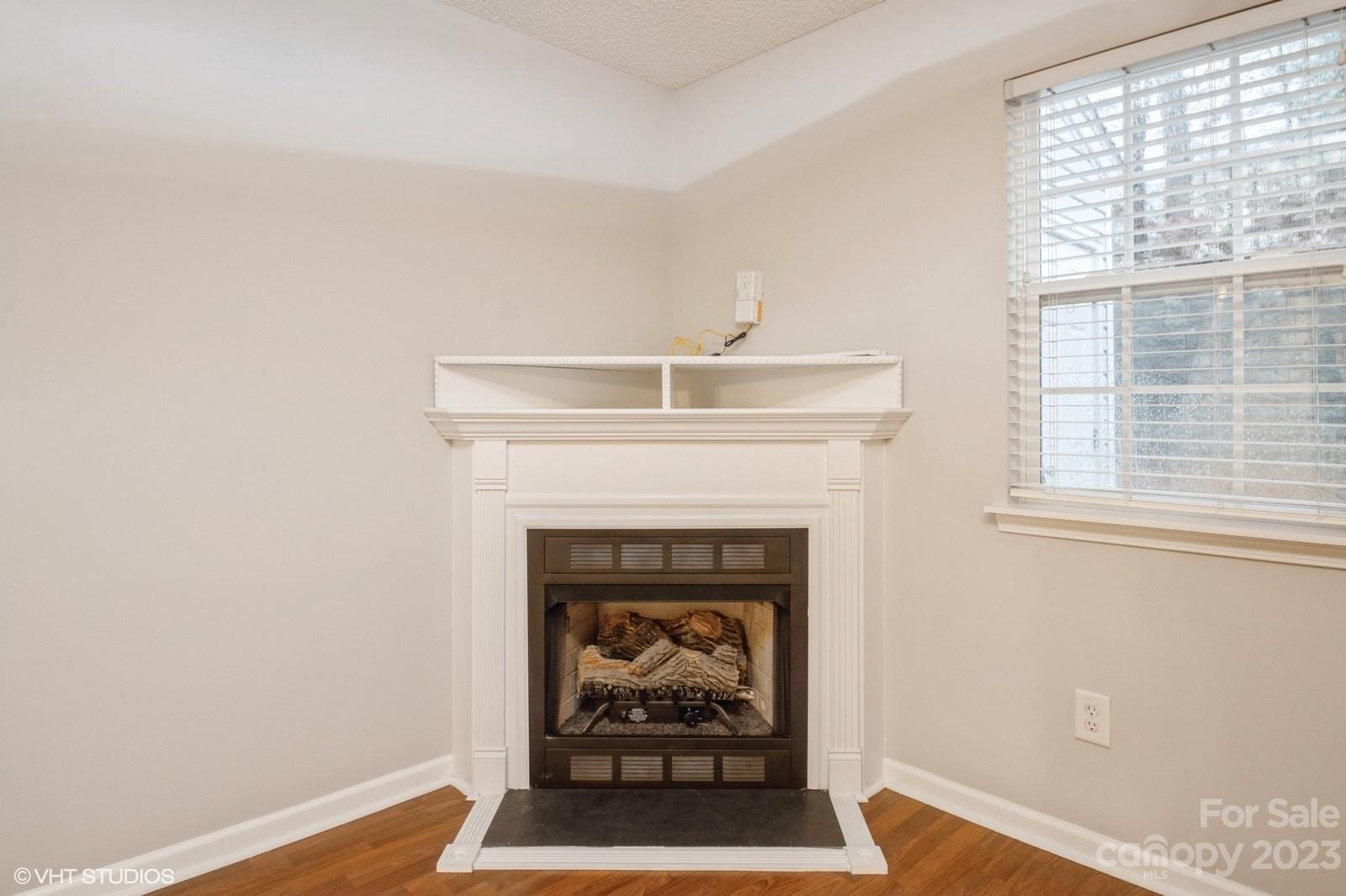 8334 Rudolph Road Charlotte, NC 28216 - Photo 9 of 31 a living room with furniture and a fireplace