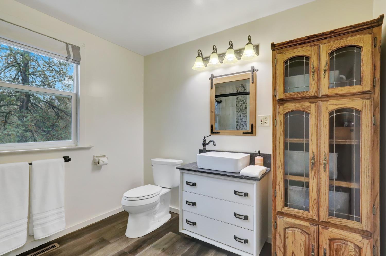 11625 Tyler Foote Road Nevada City, CA 95959 - Photo 18 of 96 a bathroom with a toilet a sink and a mirror