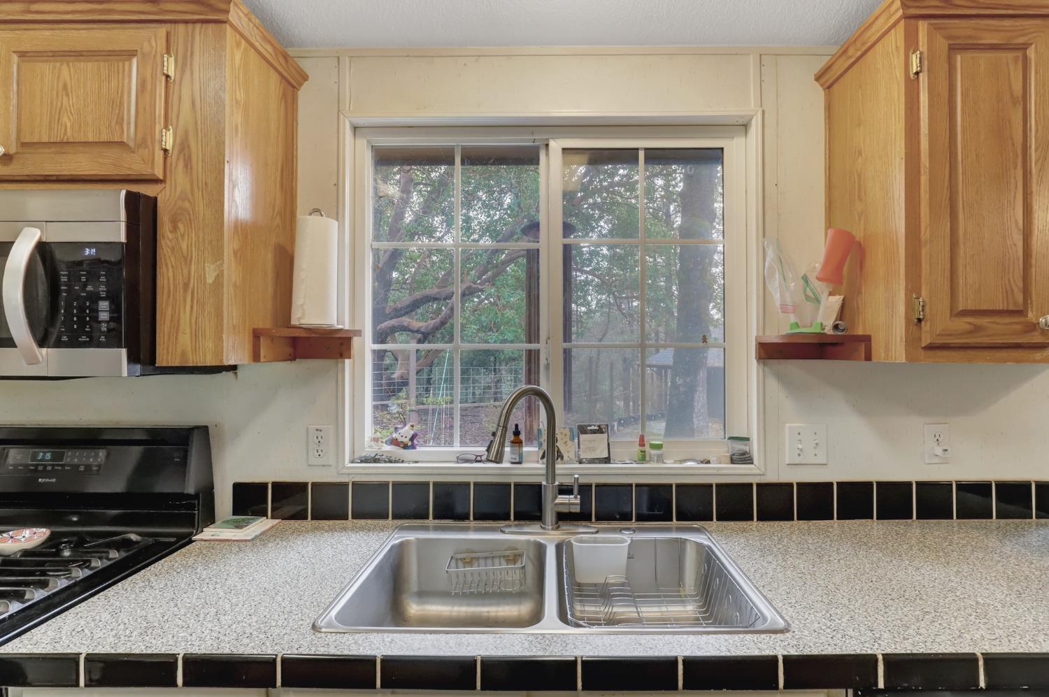 11625 Tyler Foote Road Nevada City, CA 95959 - Photo 44 of 96 a kitchen with a sink a counter top space and cabinets