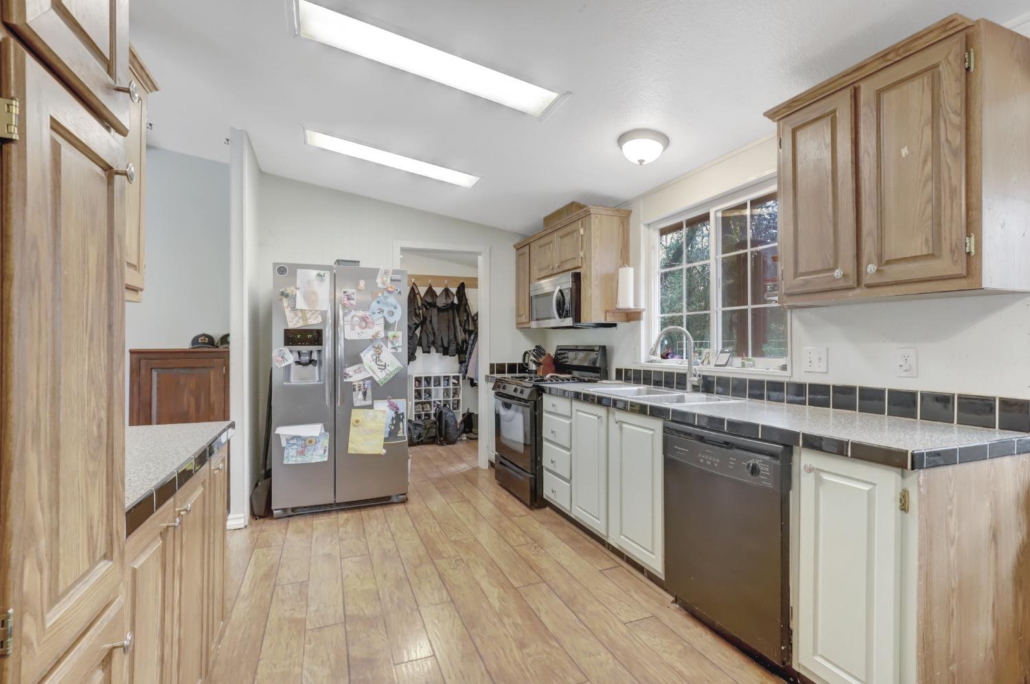11625 Tyler Foote Road Nevada City, CA 95959 - Photo 47 of 96 a kitchen with stainless steel appliances granite countertop a stove and a sink