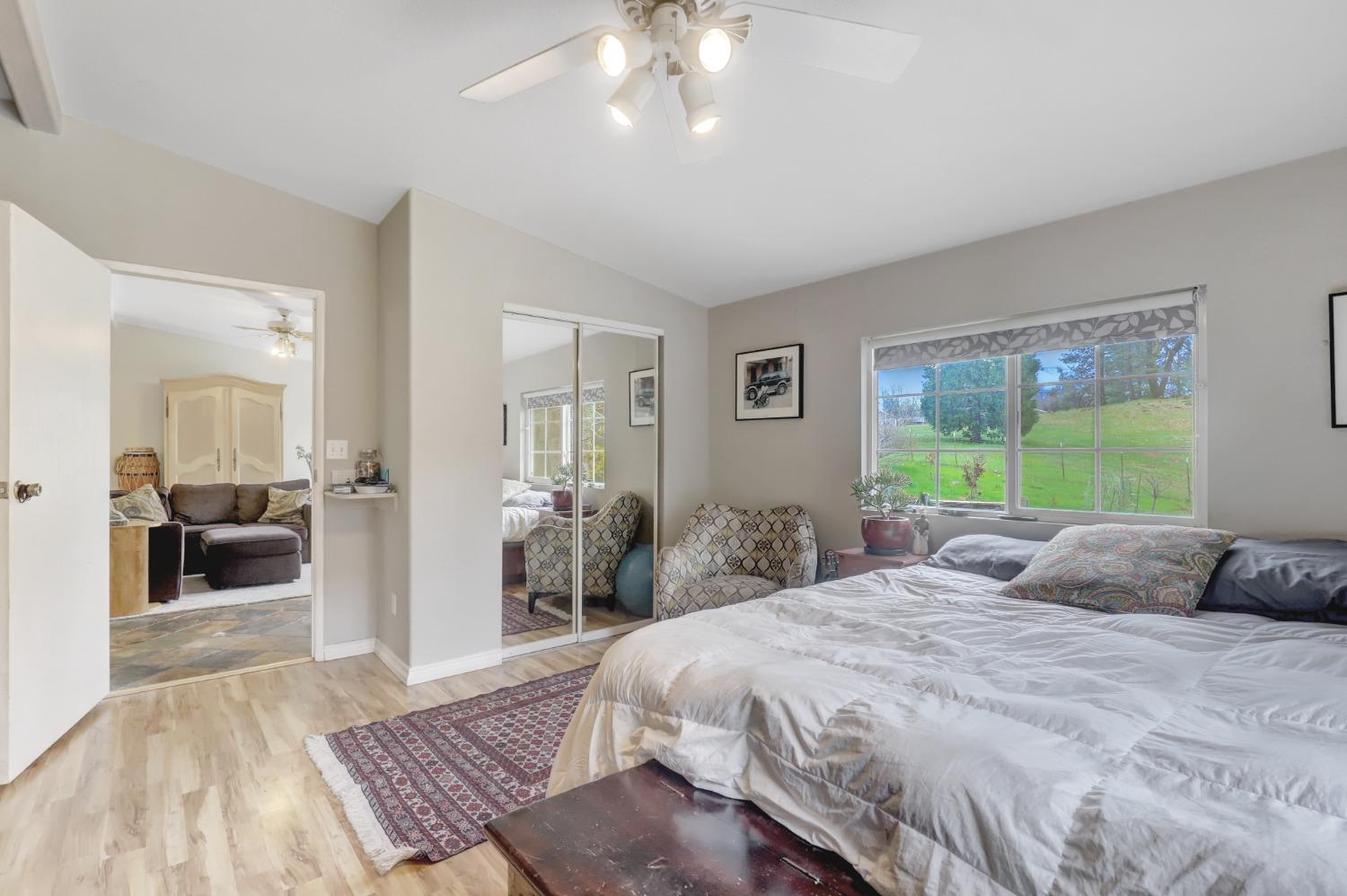 11625 Tyler Foote Road Nevada City, CA 95959 - Photo 51 of 96 a bedroom with a large bed and a chandelier