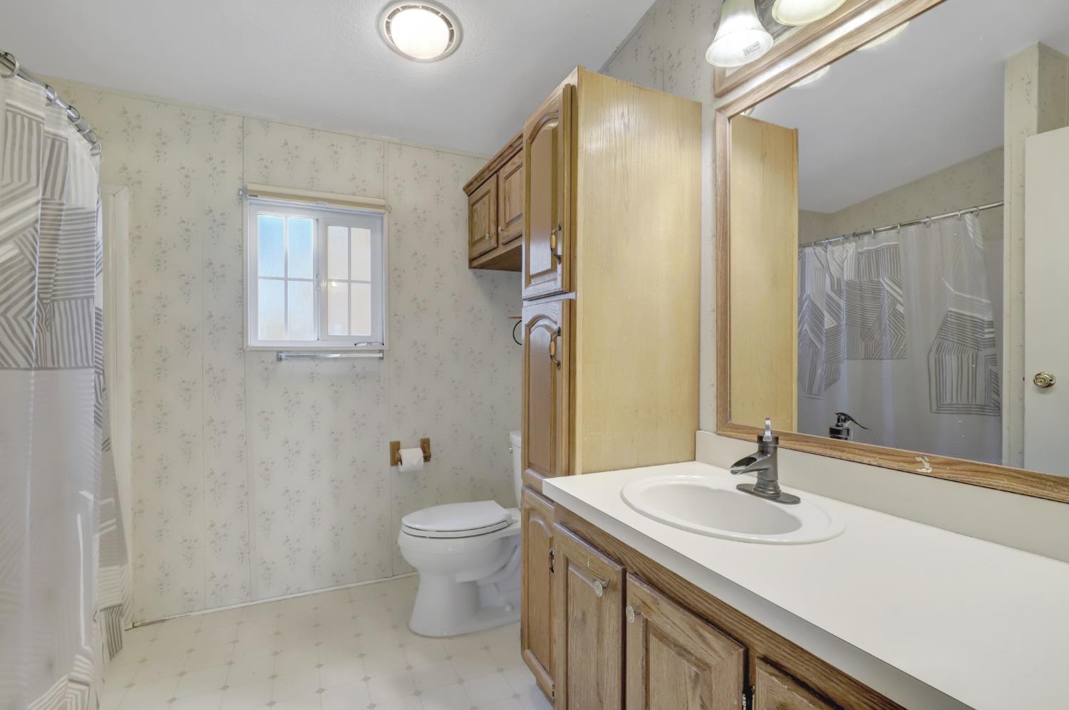 11625 Tyler Foote Road Nevada City, CA 95959 - Photo 57 of 96 a bathroom with a granite countertop sink toilet and shower
