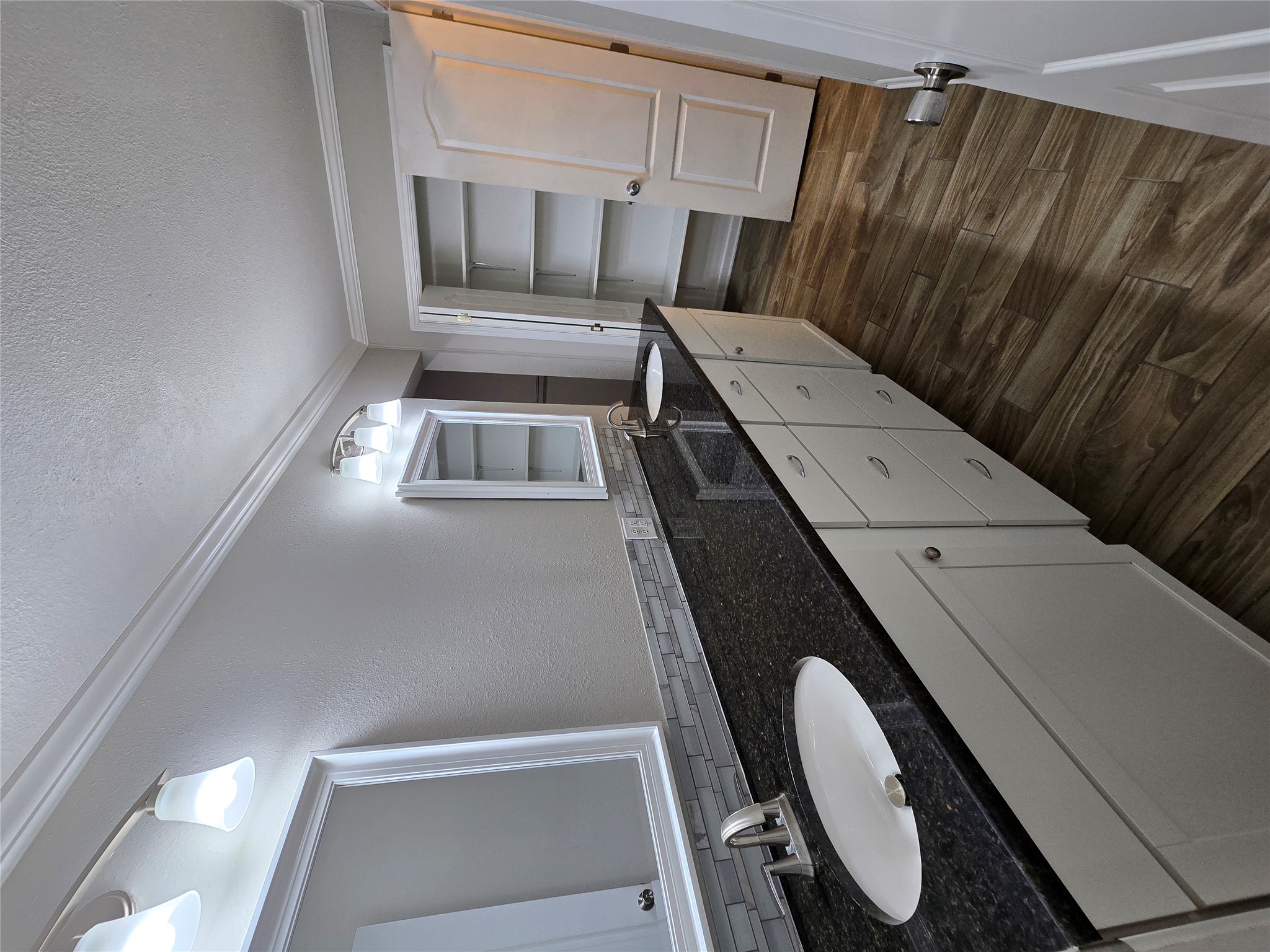 205 East Cherokee Drive Harker Heights, TX 76548 - Photo 15 of 23 Dual vanity with dark granite counters and a spacious built-in closet provides practical elegance in this primary bath.