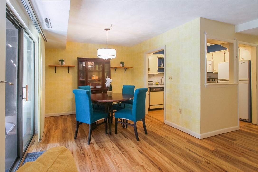 196 Old River Road, Unit 137 Lincoln, RI 02865 - Photo 15 of 21 The dining area is conveniently located next to the kitchen but overlooks the living room and also looks outside through the sliding doors to the covered and screened in patio to the communal green space beyond.