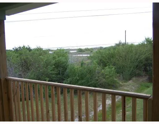a view of a balcony with yard
