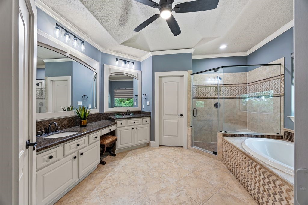 27722 Tiverton Court Spring, TX 77386 - Photo 16 of 33 The luxurious primary suite features the ultimate convenience of separate, dedicated 'his' and 'her' walk-in wardrobe alcoves, providing private, streamlined dressing spaces.