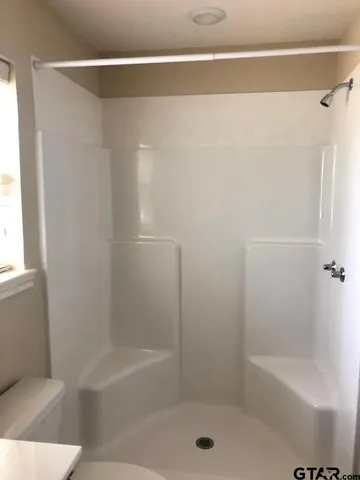 a bathroom with a shower and a bathtub