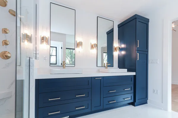 a bathroom with a double vanity sink and a mirror