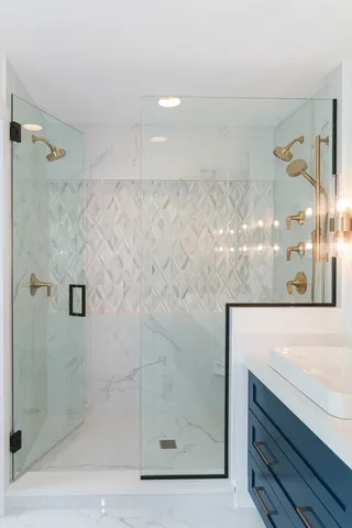 a bathroom with a shower and mirror