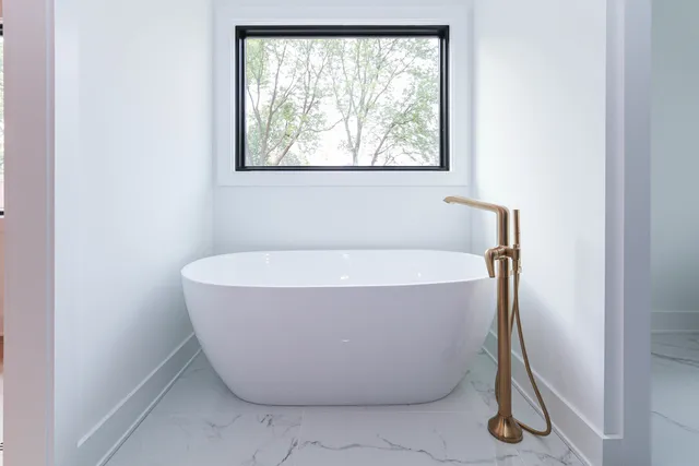 a white bath tub sitting in a bathroom