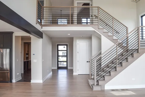 a view of entryway and hall with wooden floor