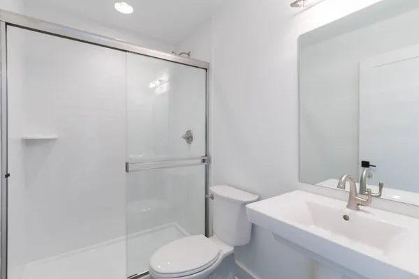 a bathroom with a sink toilet and shower