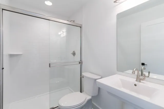 a bathroom with a sink toilet and shower