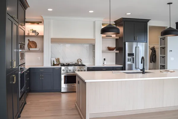 a kitchen with stainless steel appliances granite countertop a sink and a stove