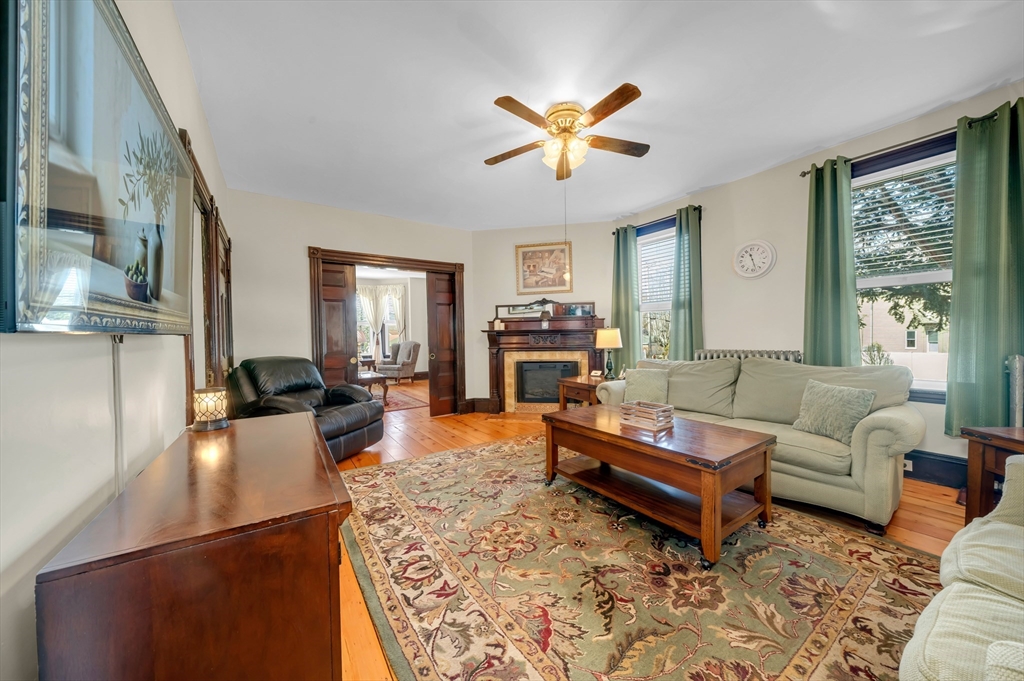 59 Washington Street Ipswich, MA 01938 - Photo 14 of 42 a living room with furniture and a fireplace