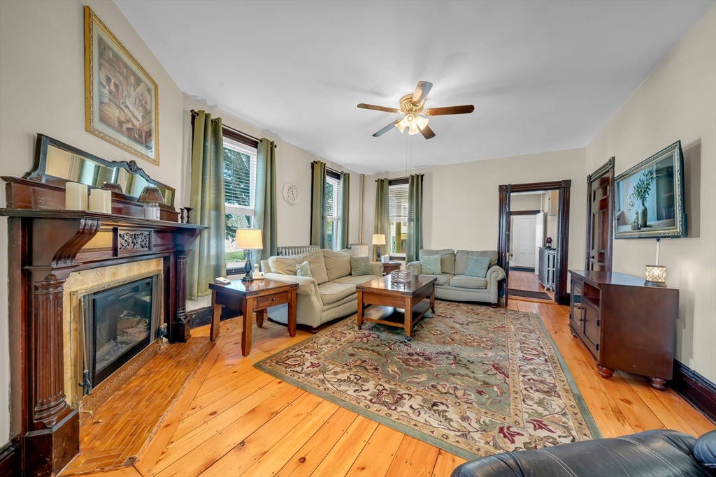 59 Washington Street Ipswich, MA 01938 - Photo 15 of 42 a living room with furniture and a fireplace