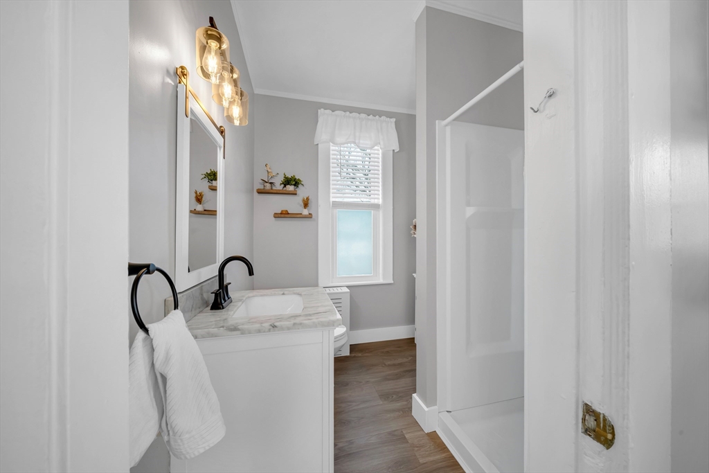59 Washington Street Ipswich, MA 01938 - Photo 22 of 42 a bathroom with a sink and mirror