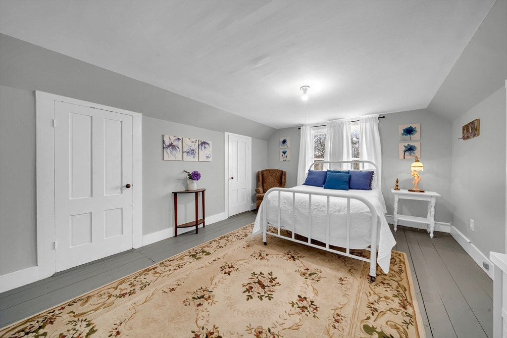 59 Washington Street Ipswich, MA 01938 - Photo 39 of 42 a bedroom with a bed and a dresser