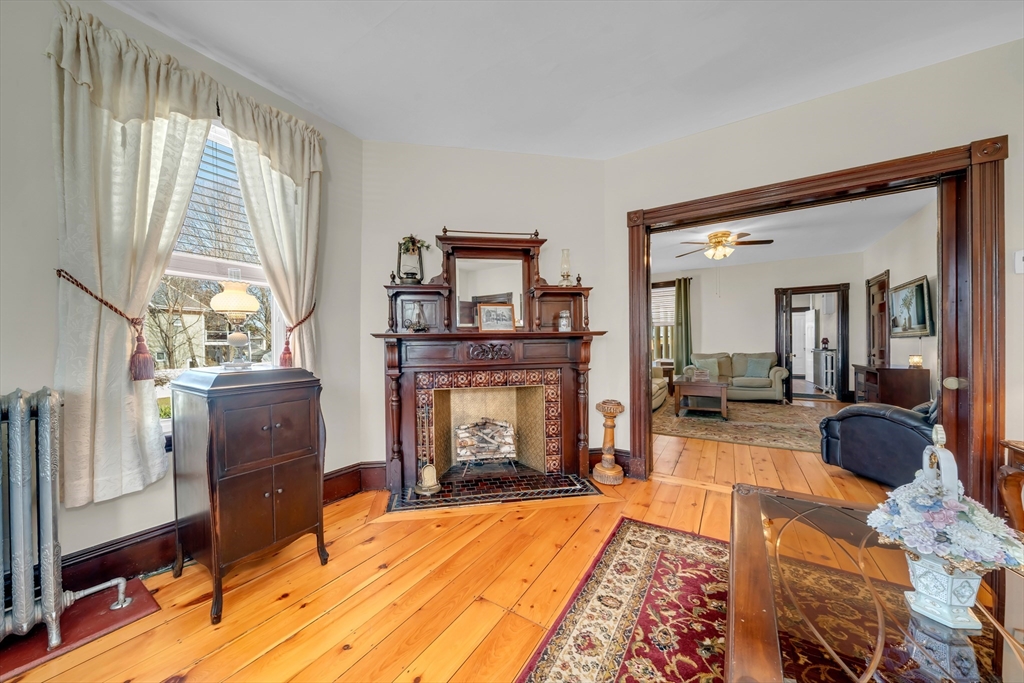 59 Washington Street Ipswich, MA 01938 - Photo 10 of 42 a living room with furniture and a fireplace