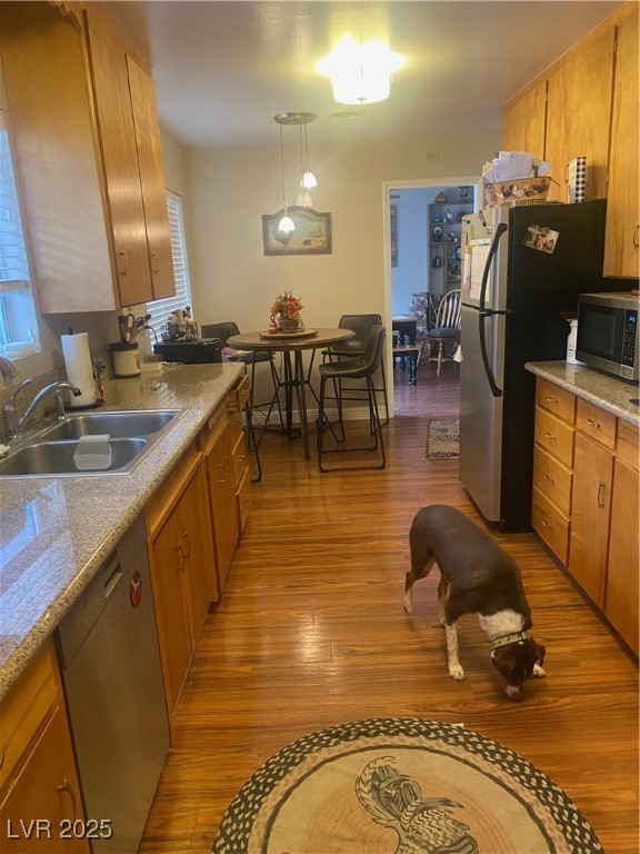Undisclosed Address Boulder City, NV 89005 - Photo 18 of 19 Kitchen with brown cabinets, a sink, dishwashing m