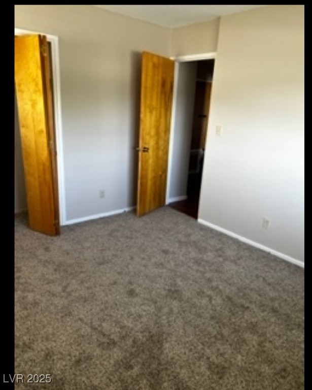 Undisclosed Address Boulder City, NV 89005 - Photo 8 of 19 Unfurnished bedroom with carpet flooring and baseb