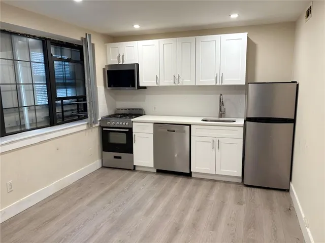 a kitchen with a stove and a microwave