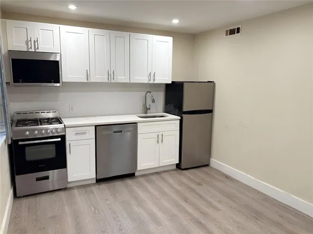 a view of a room with wooden floor and closet