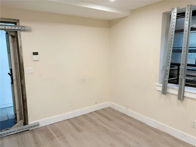 a view of a room with wooden floor