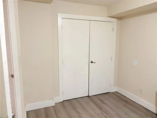 an empty room with wooden floor