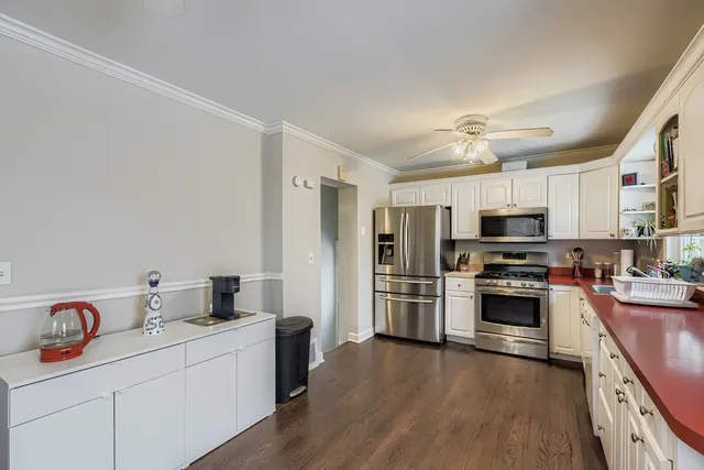 a kitchen with stainless steel appliances a stove refrigerator sink and microwave