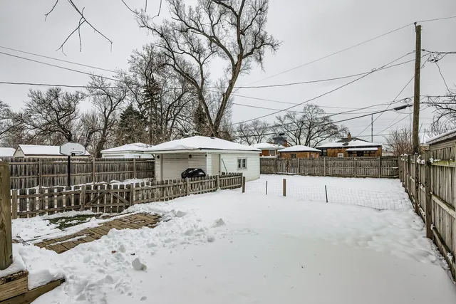 a view of a covered with snow in the backyard