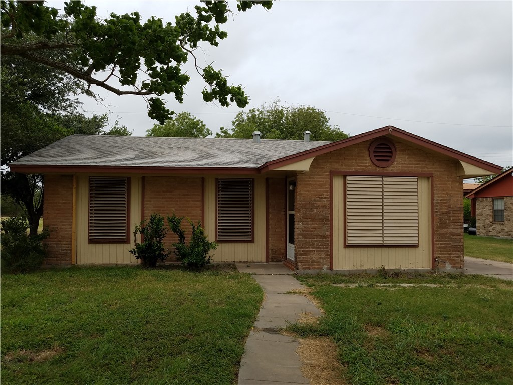 501 North Gregory Gregory, TX 78374 - Photo 1 of 6 a front view of a house with a yard and garage
