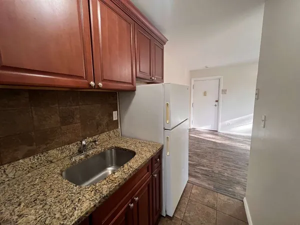 a kitchen with a sink a stove and cabinets