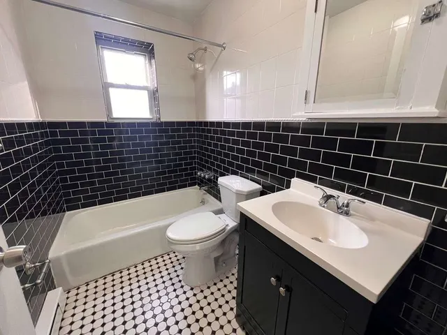 a bathroom with a sink a toilet and mirror
