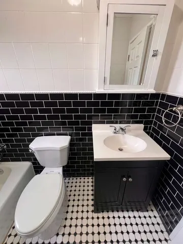 a bathroom with a sink toilet and mirror