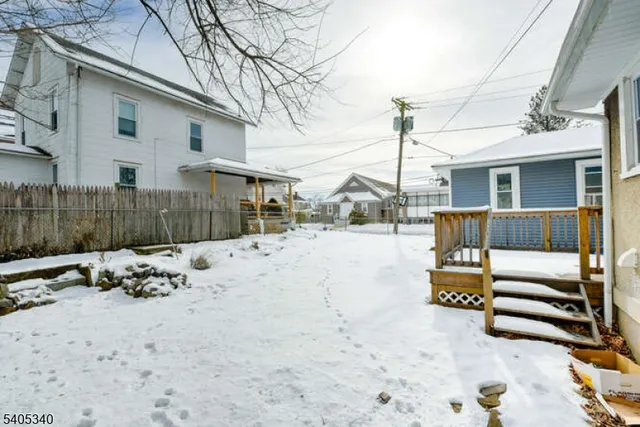 a view of a house with a wooden deck