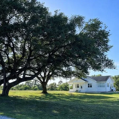 a white house with yard in front of it