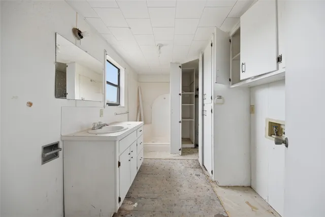 a spacious bathroom with a double vanity sink and a mirror