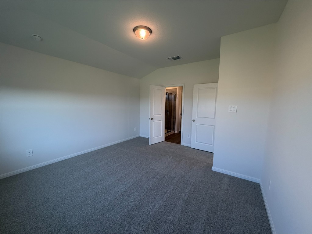 113 Honey Bee Road Jarrell, TX 76537 - Photo 9 of 10 Unfurnished bedroom with lofted ceiling and carpet