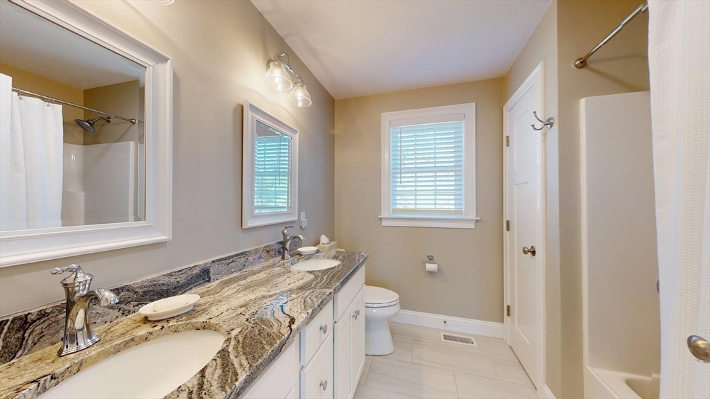 287 Wareham Street Middleboro, MA 02346 - Photo 11 of 28 a bathroom with a granite countertop sink toilet and shower