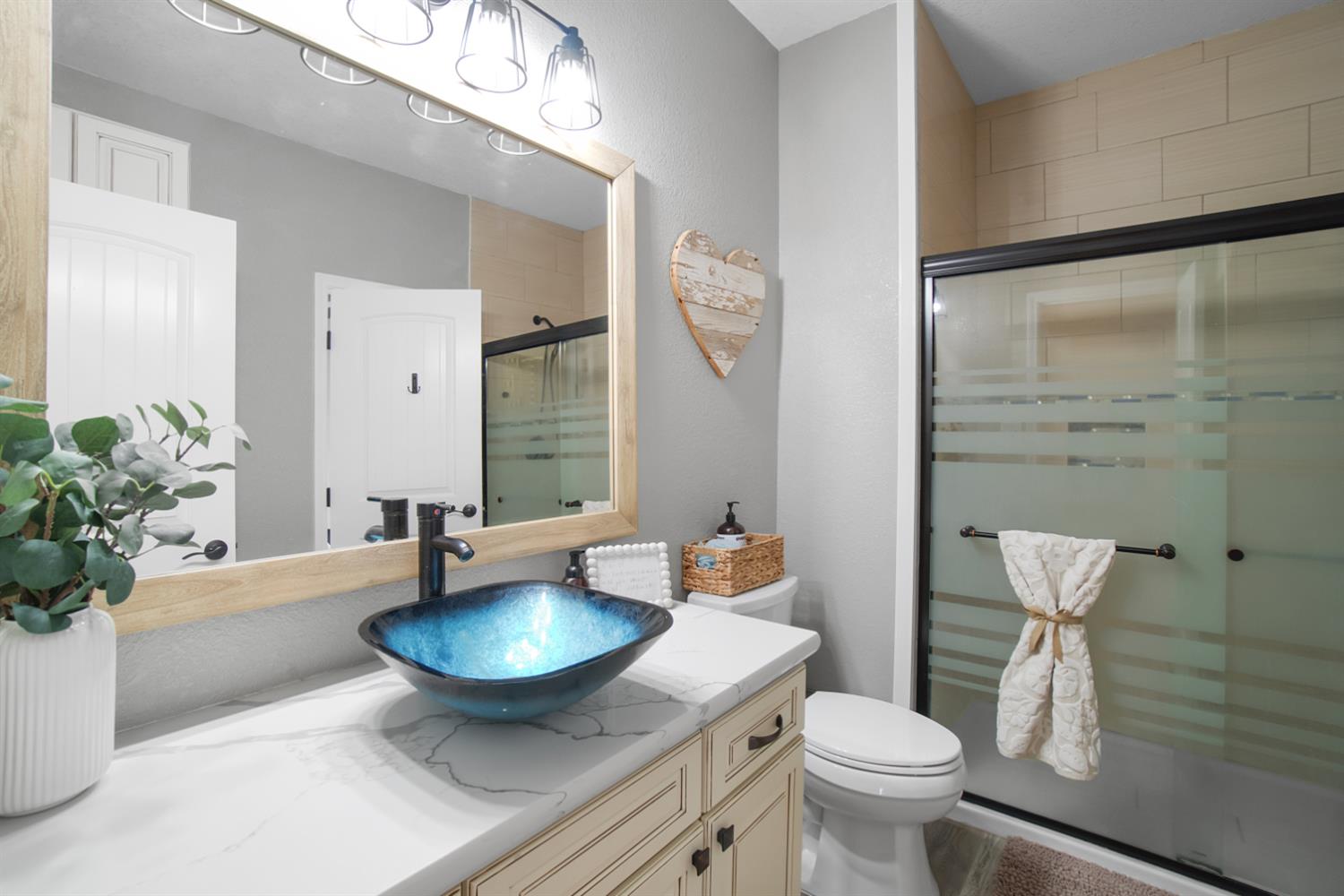7991 South Shingle Road Shingle Springs, CA 95682 - Photo 33 of 58 a bathroom with a granite countertop toilet a sink and a mirror