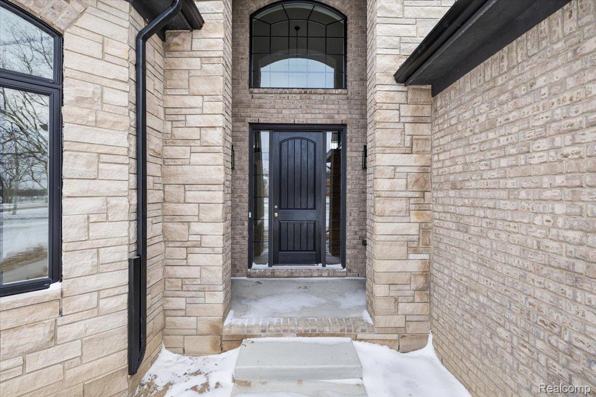 53650 Romeo Plank Road Macomb, MI 48042 - Photo 6 of 64 Property entrance featuring stone siding