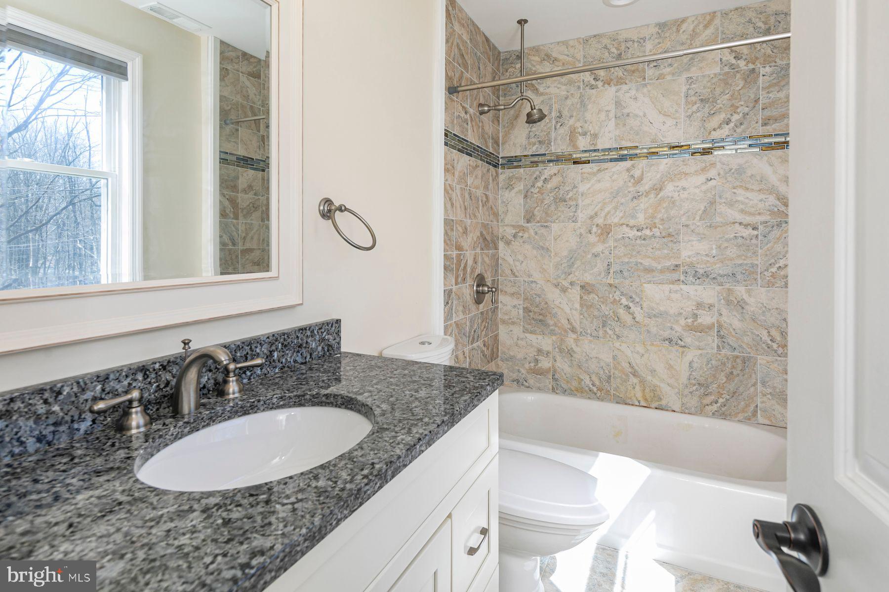 310 Hollow Road Skillman, NJ 08558 - Photo 27 of 32 a bathroom with a granite countertop sink and a mirror
