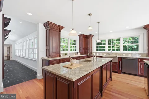 a dining room with furniture a chandelier and wooden floor