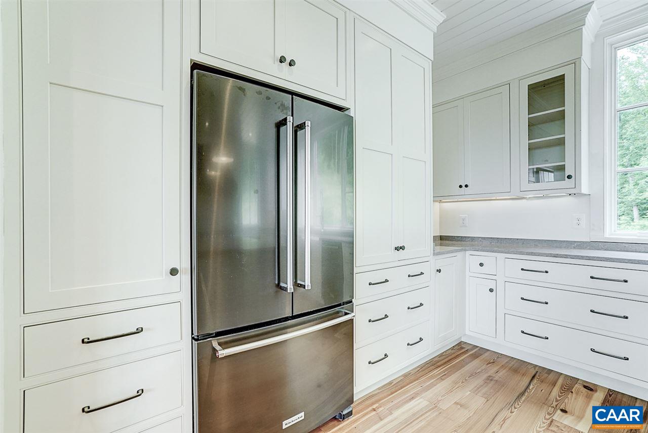 901 Tilman Road Charlottesville, VA 22901 - Photo 20 of 49 a kitchen with white cabinets and stainless steel appliances wooden floor