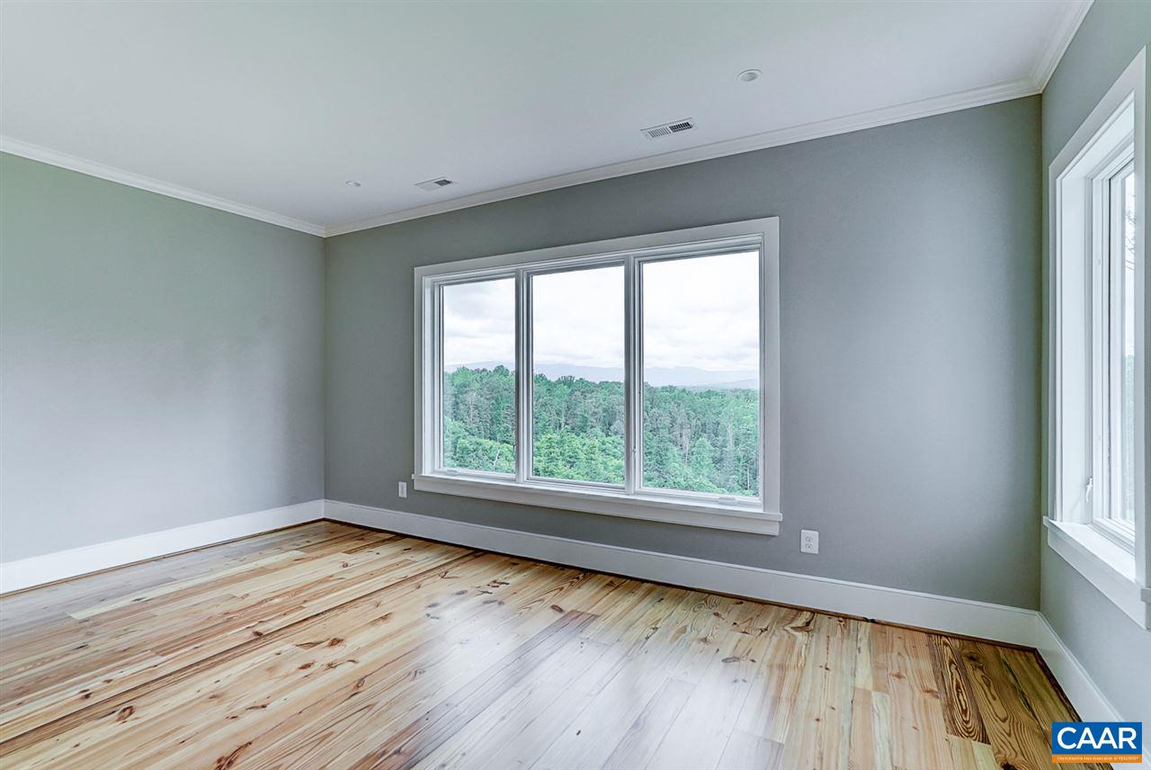 901 Tilman Road Charlottesville, VA 22901 - Photo 21 of 49 a view of an empty room with wooden floor and a window