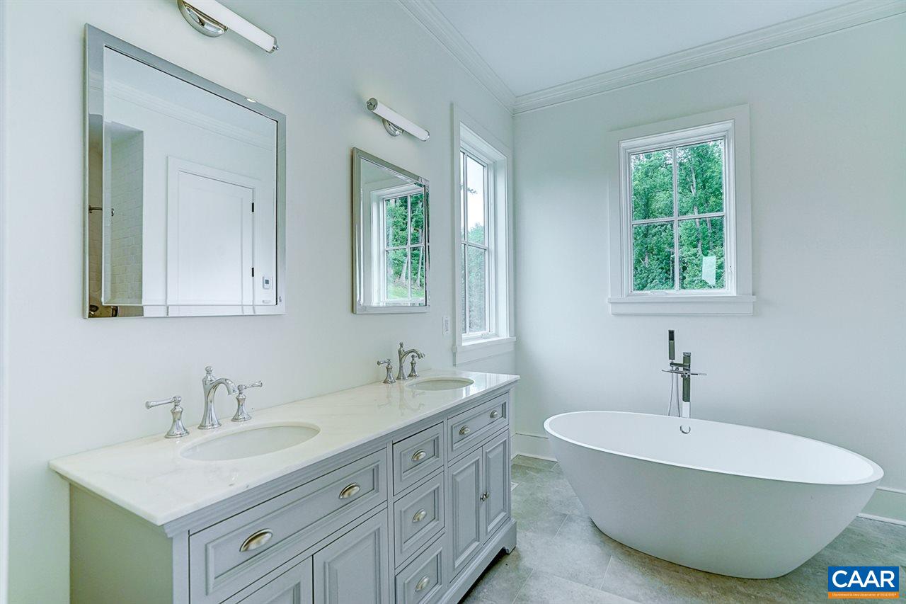 901 Tilman Road Charlottesville, VA 22901 - Photo 22 of 49 a bathroom with a double vanity sink a mirror and a window
