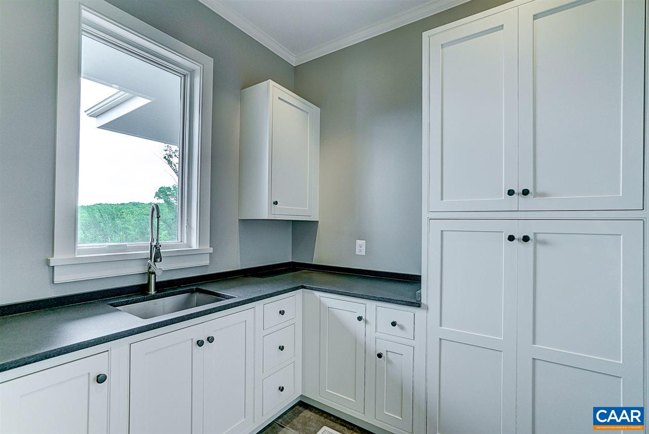 901 Tilman Road Charlottesville, VA 22901 - Photo 27 of 49 a kitchen with granite countertop white cabinets and window