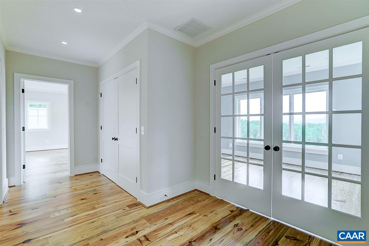 901 Tilman Road Charlottesville, VA 22901 - Photo 30 of 49 a view of empty room with wooden floor and fan